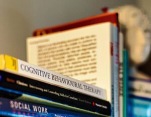 CBT book on shelf with other books