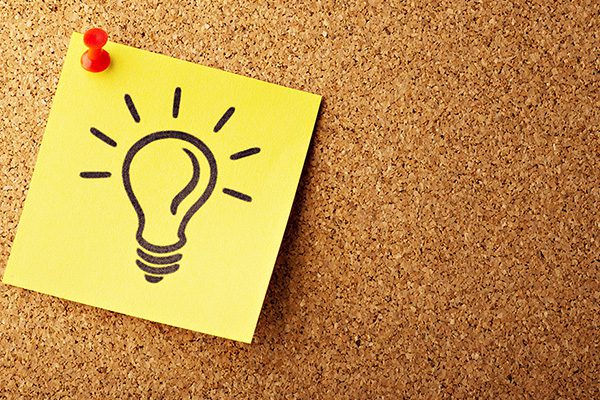 Picture of light bulb on a pinned yellow note