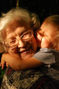 Older woman comforting child as happens in age regression therapy