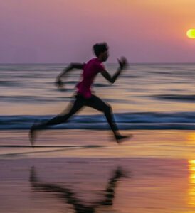 picture or blurred man running on a beach as a stress responce