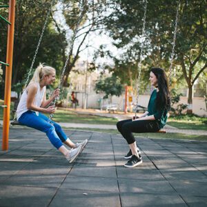 Picture of good rapport between friends on swings