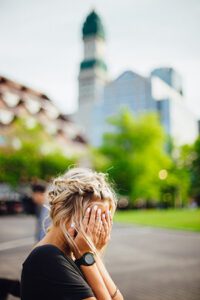 Stressed woman with her head in her hands
