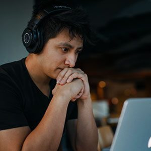 Man staring at a screen late at night