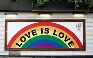 Gay Love is love poster with a rainbow on it
