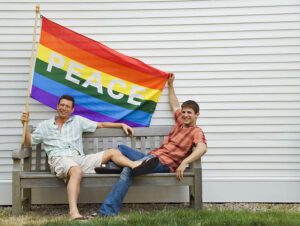 Gay male couple with a rainbow flag