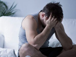 man head in hands suffering from premature ehaculation