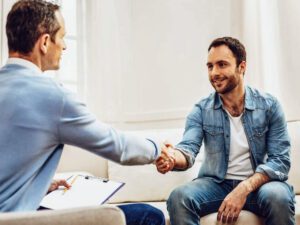 Happy therapist helping solve sexual issue for men.