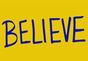 Believe sign blue writing on yellow